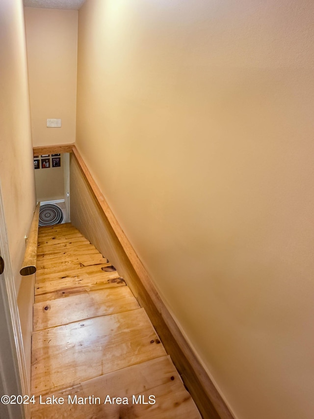 stairs featuring wood-type flooring