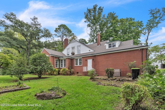 rear view of house with a lawn