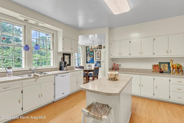 kitchen featuring white dishwasher, white cabinetry, sink, and light hardwood / wood-style flooring