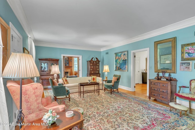 living room with light hardwood / wood-style flooring and ornamental molding