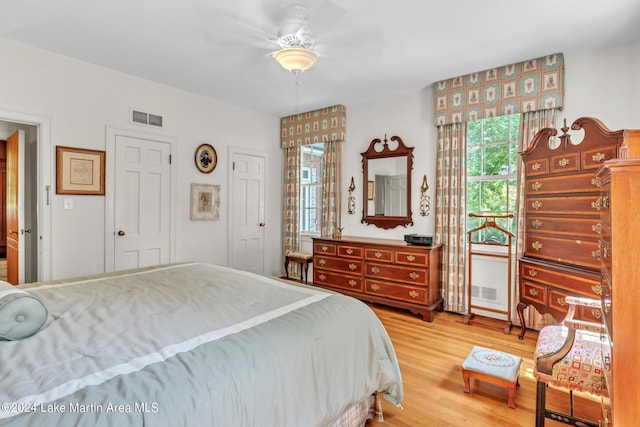 bedroom with wood-type flooring and ceiling fan