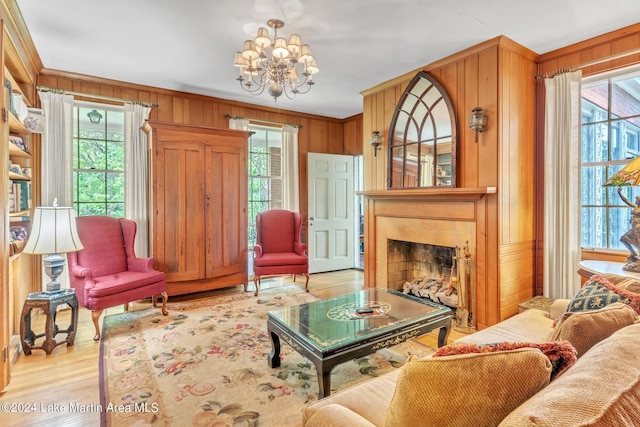 sitting room with a healthy amount of sunlight, a notable chandelier, and light hardwood / wood-style floors