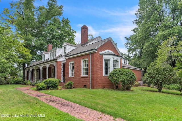 view of property exterior featuring a yard and covered porch