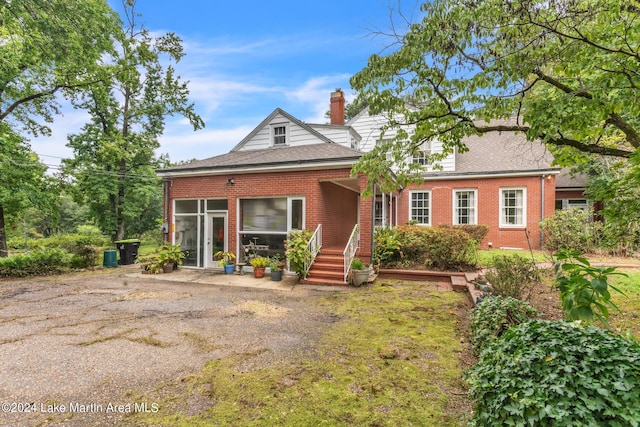 view of front of property featuring central AC and a sunroom