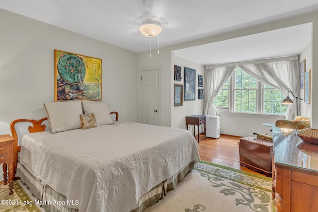 bedroom with ceiling fan and light wood-type flooring