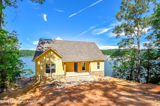 272 River Ridge Rd, Alexander City, AL 35010 - rustic home featuring roof with shingles, covered porch, stone siding, and board and batten siding