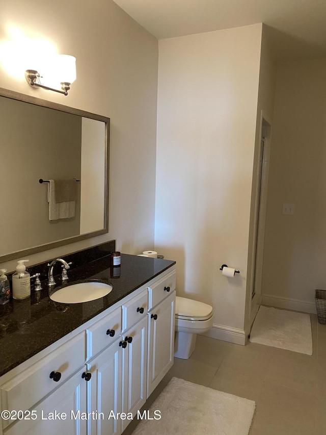 1220 Willow Way E, Alexander City, AL 35010 - bathroom featuring baseboards, toilet, tile patterned flooring, and vanity