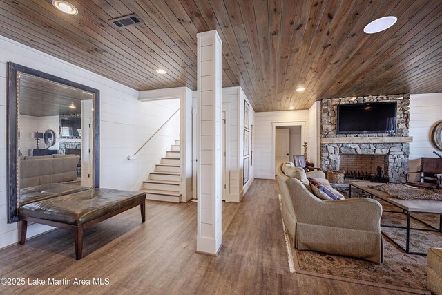 1220 Willow Way E, Alexander City, AL 35010 - living room with wood ceiling, a stone fireplace, stairs, and wood finished floors