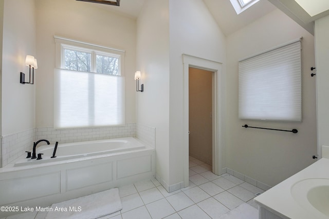 1220 Willow Way E, Alexander City, AL 35010 - full bathroom featuring lofted ceiling with skylight, tile patterned flooring, vanity, and a bath