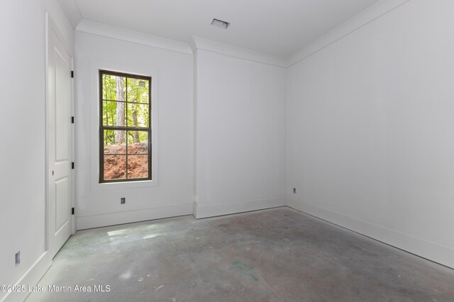 empty room featuring baseboards and unfinished concrete floors