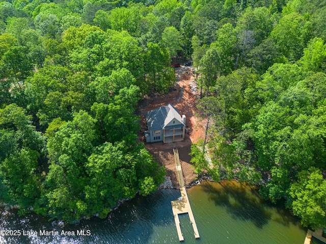 aerial view with a water view and a wooded view