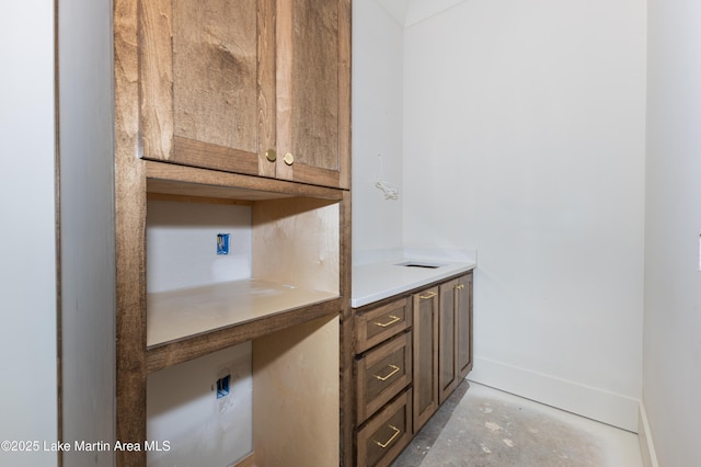 bathroom with baseboards and concrete flooring