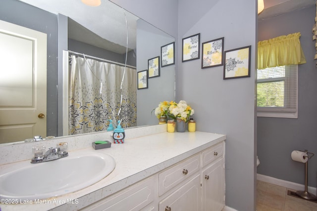 230 Lorena Dr, Alexander City, AL 35010 - bathroom featuring tile patterned floors, vanity, baseboards, and curtained shower