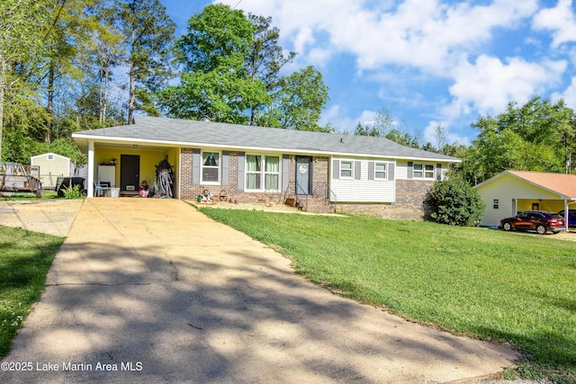 230 Lorena Dr, Alexander City, AL 35010 - ranch-style home with a front yard, brick siding, a carport, and driveway