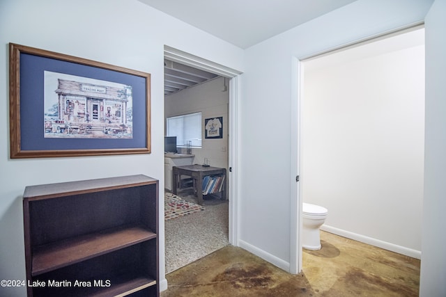 hall featuring concrete flooring