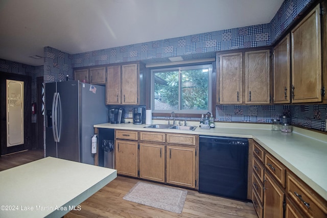 kitchen with decorative backsplash, stainless steel fridge, sink, light hardwood / wood-style flooring, and dishwasher