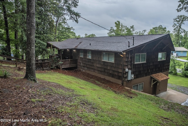 back of house with a lawn and a wooden deck