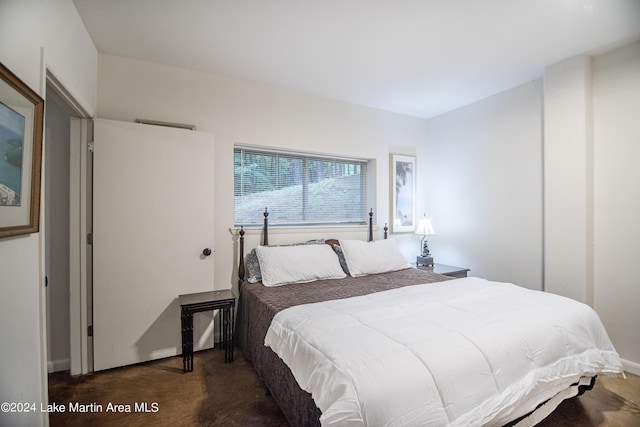 bedroom featuring dark colored carpet