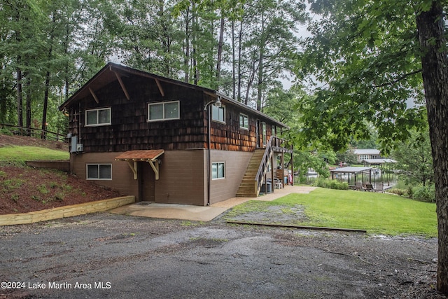 view of home's exterior with a yard and a patio