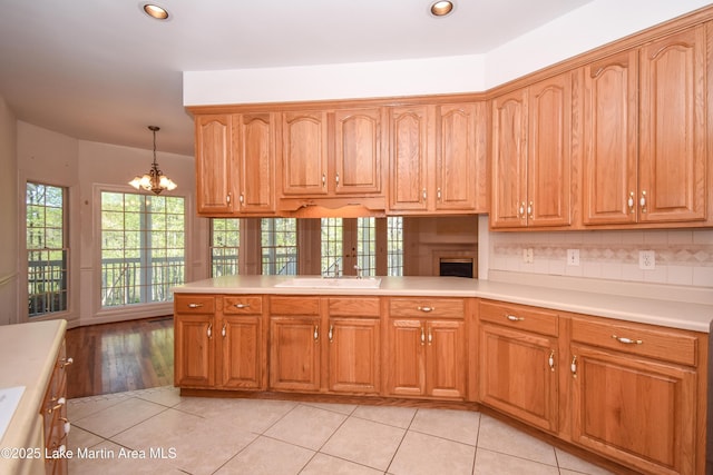 1647 Timber Trl, Alexander City, AL 35010 - kitchen with recessed lighting, light countertops, light tile patterned floors, hanging light fixtures, and a notable chandelier