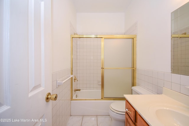 1647 Timber Trl, Alexander City, AL 35010 - bathroom featuring tile patterned floors, vanity, tile walls, toilet, and shower / bath combination with glass door