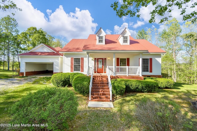 1647 Timber Trl, Alexander City, AL 35010 - cape cod house with a front lawn, driveway, a porch, an attached garage, and stairs
