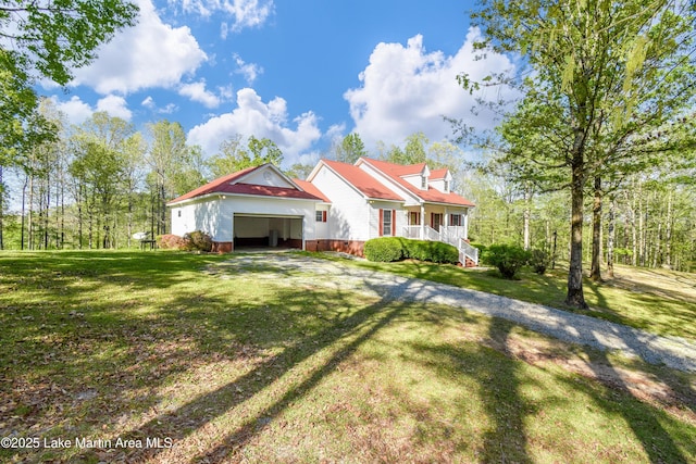 1647 Timber Trl, Alexander City, AL 35010 - view of front of home with driveway, a garage, and a front yard