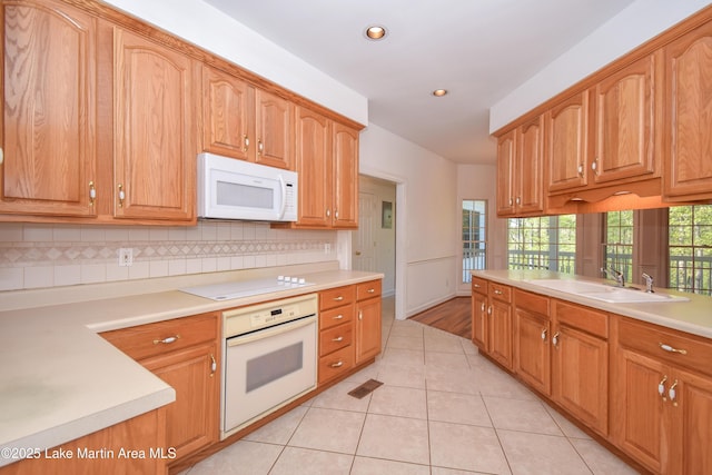 1647 Timber Trl, Alexander City, AL 35010 - kitchen with a sink, light tile patterned flooring, white appliances, backsplash, and recessed lighting