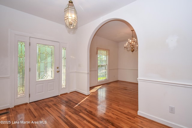 1647 Timber Trl, Alexander City, AL 35010 - entryway featuring a chandelier, arched walkways, visible vents, and wood finished floors