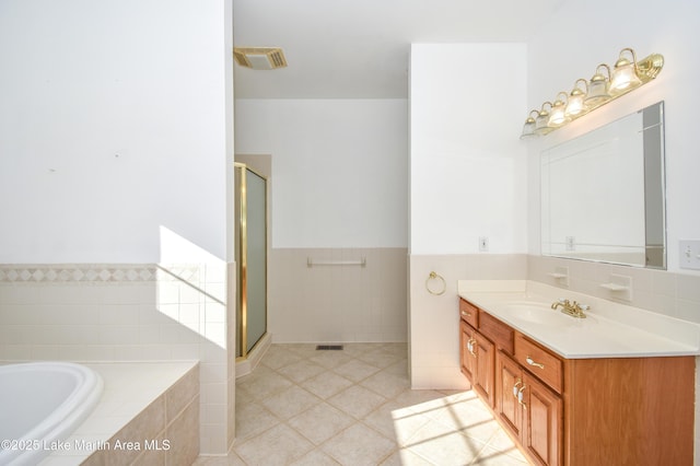 1647 Timber Trl, Alexander City, AL 35010 - full bathroom with a shower stall, tile patterned floors, a bath, vanity, and visible vents