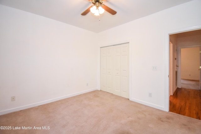 1647 Timber Trl, Alexander City, AL 35010 - unfurnished bedroom with light colored carpet, baseboards, a ceiling fan, and a closet