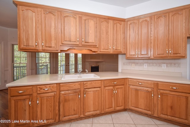 1647 Timber Trl, Alexander City, AL 35010 - kitchen with light countertops, tasteful backsplash, a healthy amount of sunlight, and a sink
