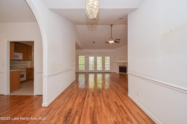 1647 Timber Trl, Alexander City, AL 35010 - interior space with vaulted ceiling, light wood-style flooring, and ceiling fan with notable chandelier