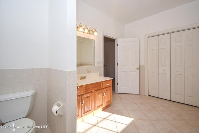 1647 Timber Trl, Alexander City, AL 35010 - bathroom with a closet, vanity, tile walls, toilet, and tile patterned flooring