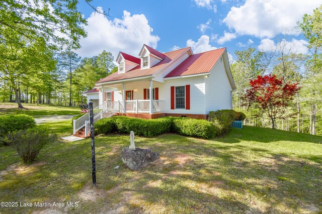 1647 Timber Trl, Alexander City, AL 35010 - view of front of home featuring metal roof, a front yard, and covered porch
