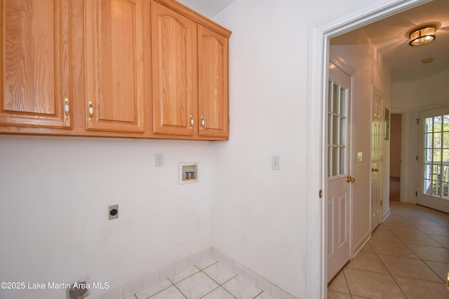 1647 Timber Trl, Alexander City, AL 35010 - laundry room featuring light tile patterned floors, hookup for an electric dryer, hookup for a washing machine, baseboards, and cabinet space