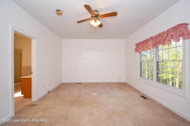 1647 Timber Trl, Alexander City, AL 35010 - spare room featuring light carpet, baseboards, visible vents, and ceiling fan