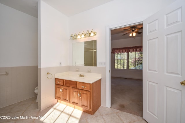 1647 Timber Trl, Alexander City, AL 35010 - full bathroom featuring tile walls, tile patterned floors, vanity, and a ceiling fan