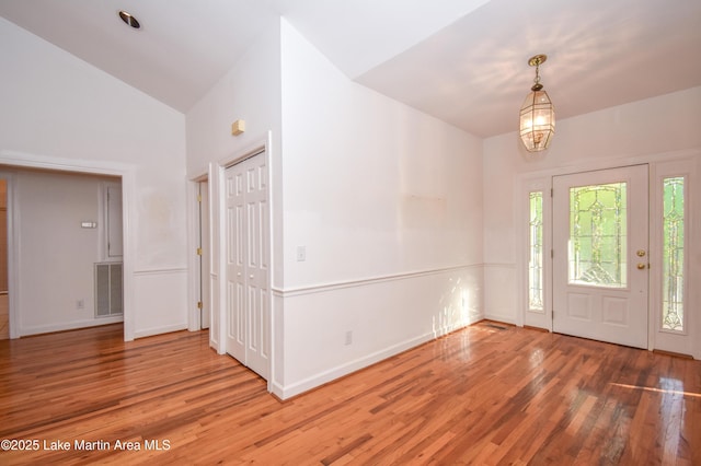 1647 Timber Trl, Alexander City, AL 35010 - foyer entrance with high vaulted ceiling, wood finished floors, visible vents, and baseboards