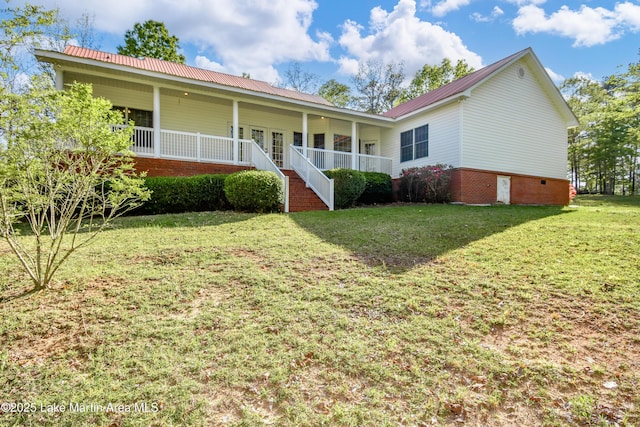 1647 Timber Trl, Alexander City, AL 35010 - view of front of home with metal roof, a front yard, and covered porch