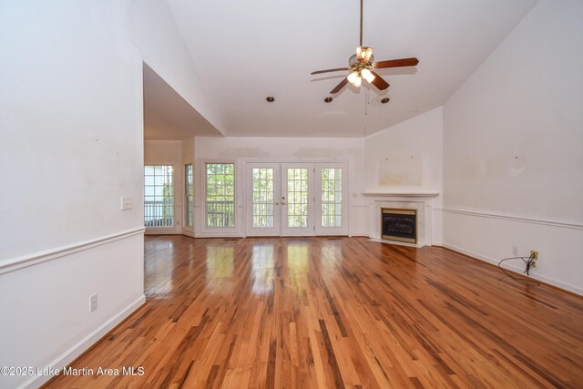 1647 Timber Trl, Alexander City, AL 35010 - unfurnished living room with light wood finished floors, a high end fireplace, vaulted ceiling, baseboards, and ceiling fan