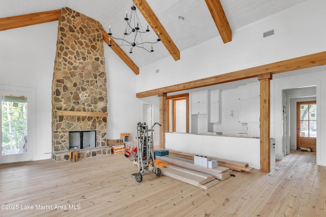 149 Bay Pt, Jacksons Gap, AL 36861 - living room with high vaulted ceiling, light wood-style floors, beam ceiling, a chandelier, and a fireplace