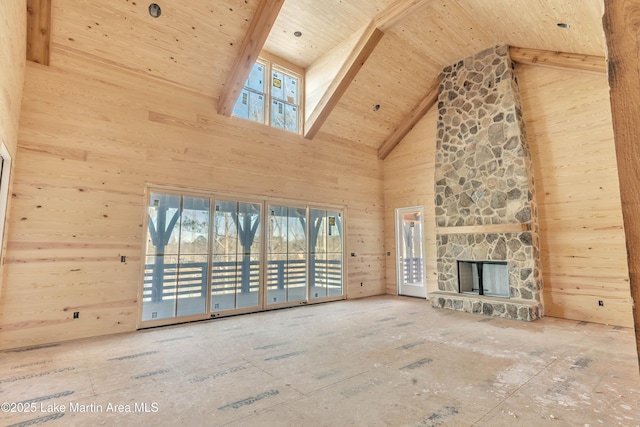 unfurnished living room with high vaulted ceiling, wood walls, a fireplace, and wooden ceiling