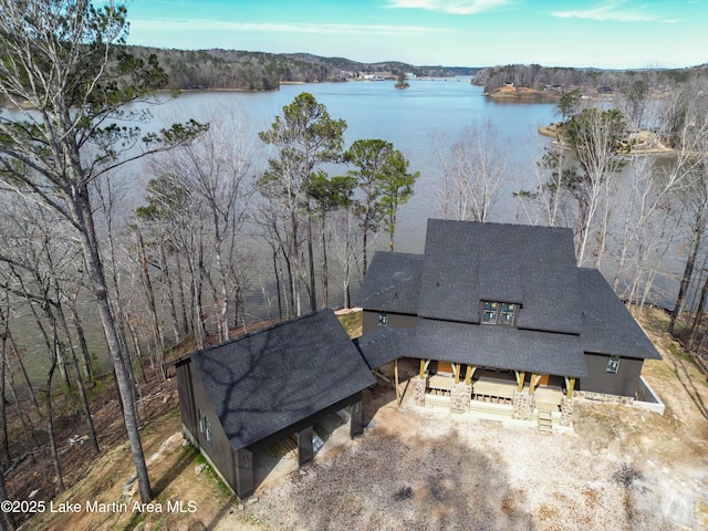 birds eye view of property featuring a water view and a forest view