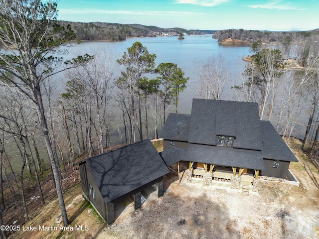 aerial view featuring a view of trees and a water view