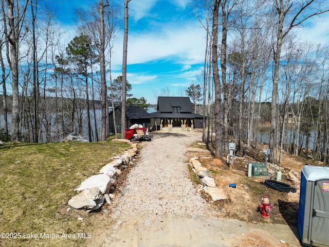 view of front of house with driveway and a front lawn