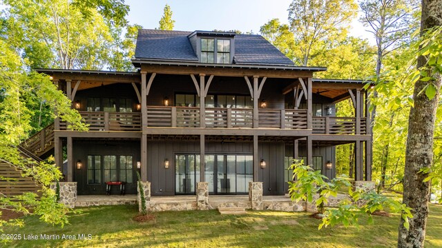 149 Bay Pt, Jacksons Gap, AL 36861 - rear view of house with a balcony, board and batten siding, a patio area, and a yard