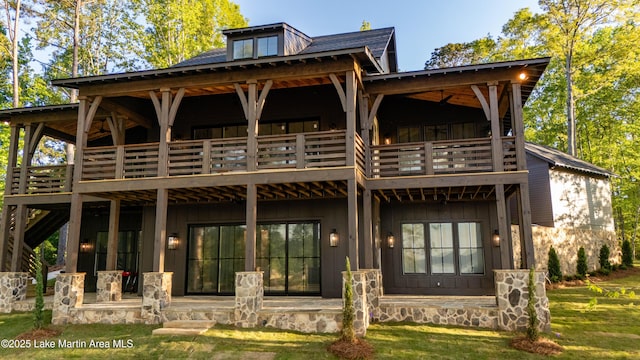 149 Bay Pt, Jacksons Gap, AL 36861 - back of house with a balcony, a patio, board and batten siding, and a lawn