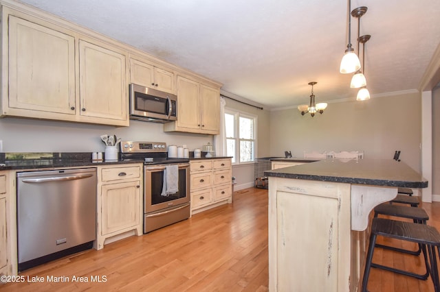241 Warrior Rd, Alexander City, AL 35010 - kitchen with dark countertops, a notable chandelier, crown molding, and appliances with stainless steel finishes