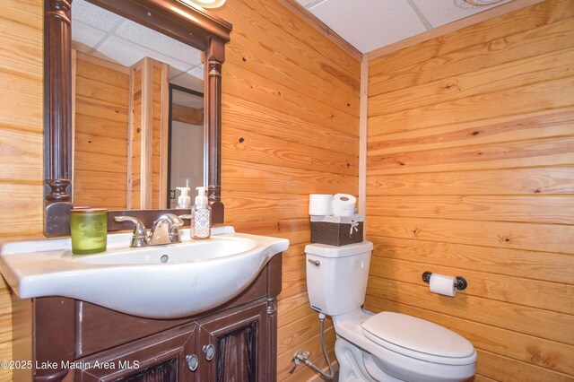 241 Warrior Rd, Alexander City, AL 35010 - bathroom with wooden walls, toilet, and vanity